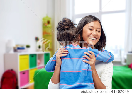 happy mother and daughter hugging at home 41302099
