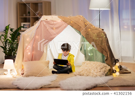 little boy with tablet pc in kids tent at home 41302156