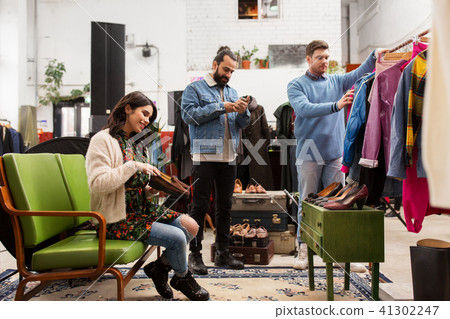 friends choosing clothes at vintage clothing store friends choosing clothes at vintage clothing store 41302247