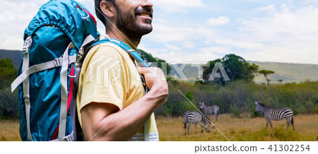 close up of man with backpack over savannah close up of man with backpack over savannah 41302254