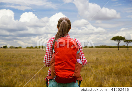 woman with backpack over african savannah woman with backpack over african savannah 41302426
