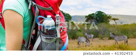 close up of woman with water bottle in backpack 41302453