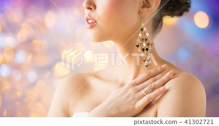 close up of beautiful woman with earrings 41302721