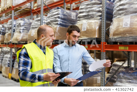 worker and businessman with clipboard at warehouse worker and businessman with clipboard at warehouse 41302742