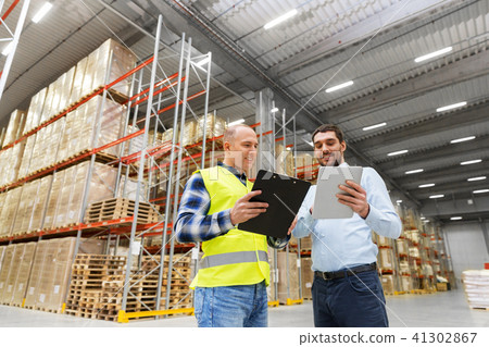 worker and businessman with tablet pc at warehouse worker and businessman with tablet pc at warehouse 41302867