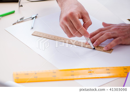 Architect working in his studio on new project Architect working in his studio on new project 41303098