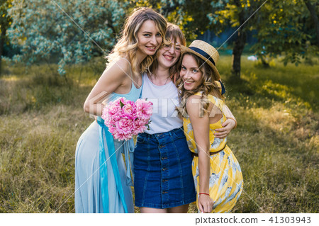 Three of girls friends outdoor in the park or forest Three of girls friends outdoor in the park or forest 41303943