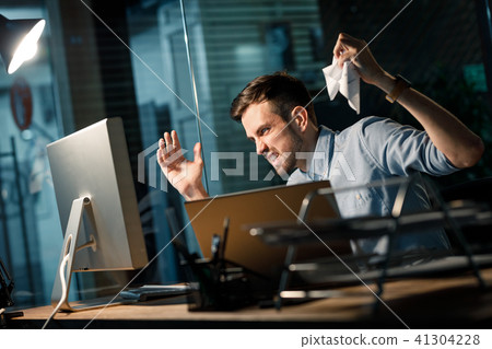 Furious man having problems with computer 41304228