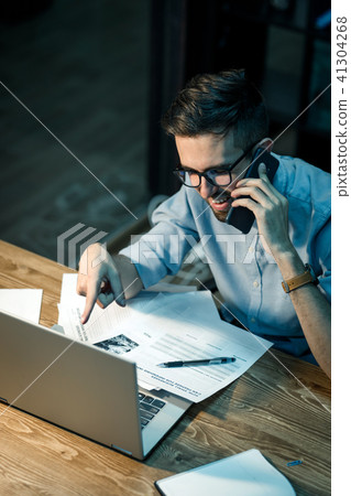 Working man with laptop having call 41304268