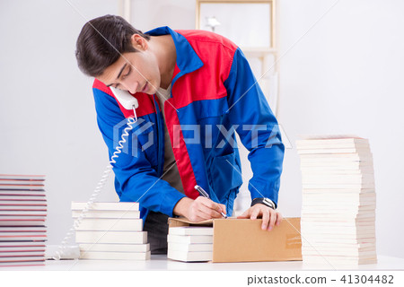 Worker in publishing house preparing book order Worker in publishing house preparing book order 41304482