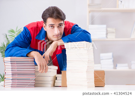 Worker in publishing house preparing book order Worker in publishing house preparing book order 41304524