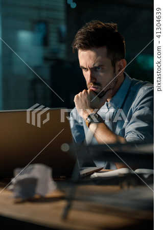 Serious man using laptop at work Serious man using laptop at work 41304639