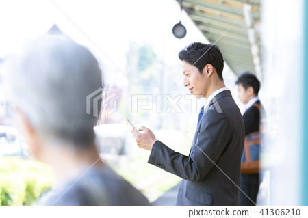 Businessman waiting for a train at the station platform Mid-level employee business image 41306210