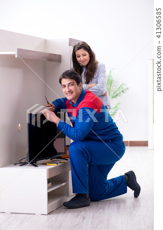 Tv repairman technician repairing tv at home 41306585