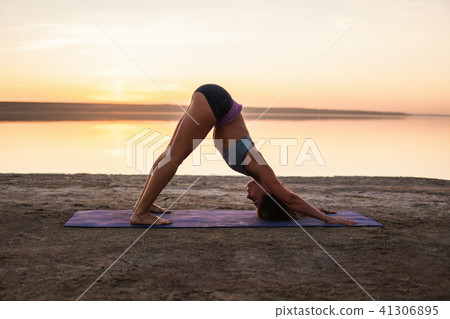 yoga woman on the beach at sunset. yoga woman on the beach at sunset. 41306895