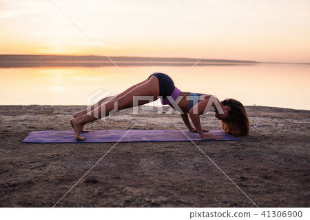 yoga woman on the beach at sunset. yoga woman on the beach at sunset. 41306900