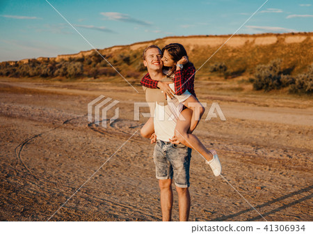 lovestory of couple on the beach On the Sunset 41306934