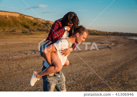 lovestory of couple on the beach On the Sunset 41306946