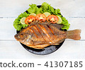 fried fish with vegetable on black dish. top view 41307185