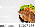 fried fish with vegetable on black dish. top view 41307186