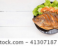 fried fish with vegetable on black dish. top view 41307187