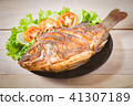 fried fish with vegetable on black dish. top view 41307189