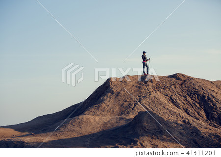 Full-length image of woman growing tourist with backpack and walking sticks 41311201