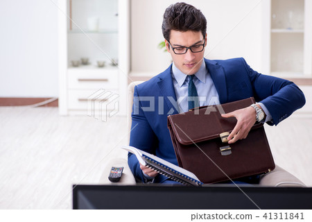Businessman watching tv in the office 41311841