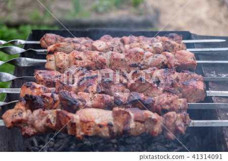 cooking barbecue pork on the coals 41314091