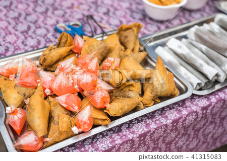 Samosa is snack fried filled puff with spicy sauce 41315083