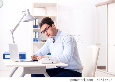 Young handsome businessman employee working in office at desk 41315692