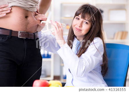 Doctor dietician giving advices to fat overweight patient 41316355