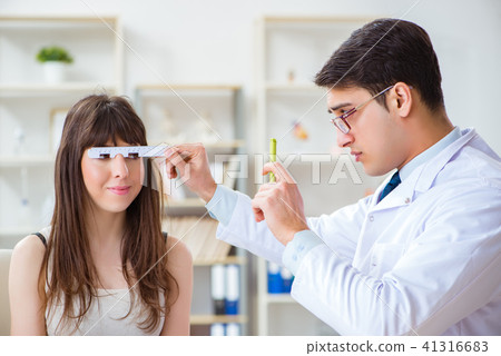 Ophthalmologist is checking up patient in eye doctor hospital Ophthalmologist is checking up patient in eye doctor hospital 41316683