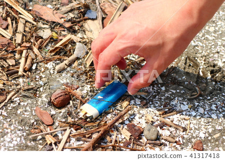 Male hand picking coastal trash Male hand picking coastal trash 41317418