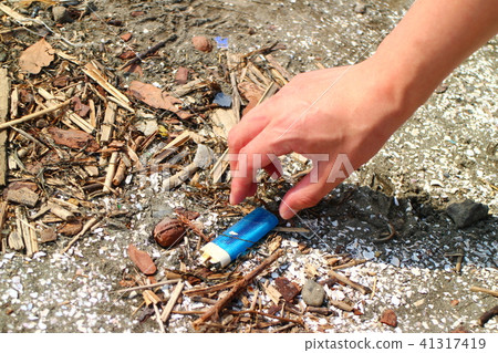 Male hand picking coastal trash Male hand picking coastal trash 41317419