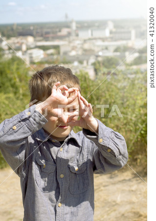 Boy pretending that he is a cameraman 41320040