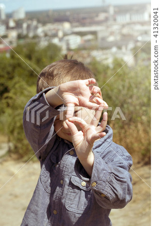 Boy pretending that he is a cameraman 41320041