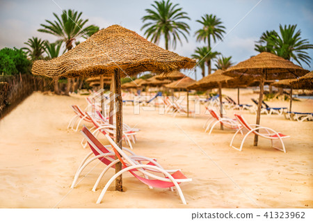 Focus on parasol. Sunbeds on snow-white sand 41323962