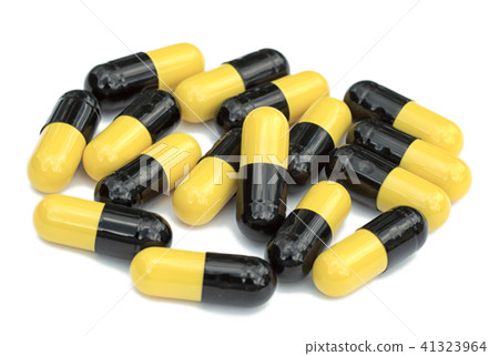Black and yellow capsules on white background Black and yellow capsules on white background 41323964