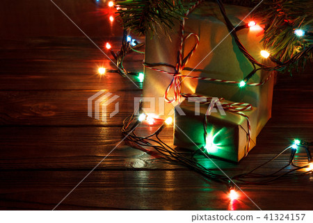 Gifts under the Christmas tree lights background 41324157