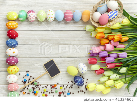 Colorful Easter eggs and tulips on wood 41324603