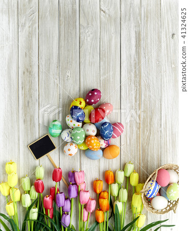 Colorful Easter eggs and tulips on wood 41324625