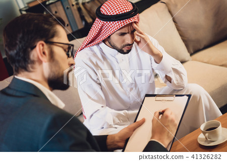 Arabic man at psychotherapist reception 41326282