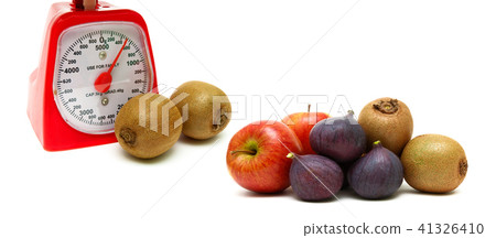 fruits and kitchen scales on a white background 41326410