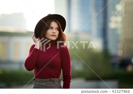 A young teenage girl in a black shirt and hat 41327968