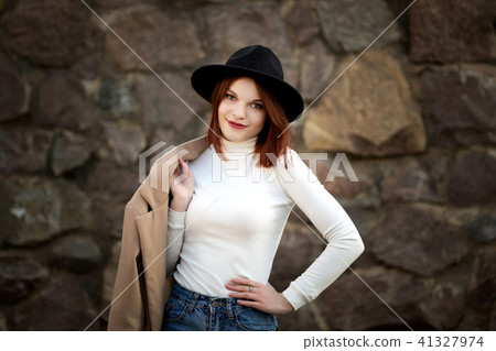 Lifestyle fashion portrait of young stylish hipster woman walking on the street. Lifestyle fashion portrait of young stylish hipster woman walking on the street. 41327974