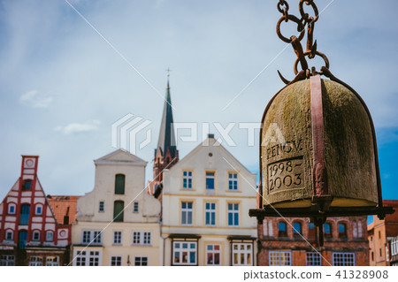 Weight of old Crane hanging in front of facade of historical buildings in Harbor Lueneburg, Lower 41328908