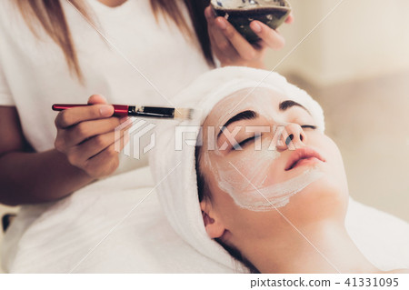Beautiful woman having a facial treatment at spa. Beautiful woman having a facial treatment at spa. 41331095