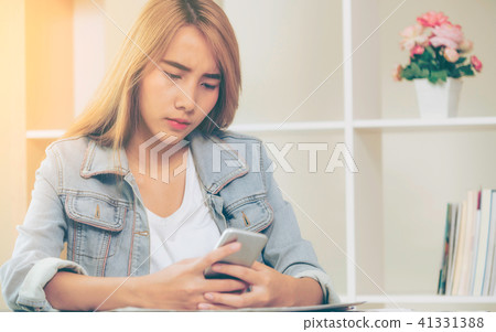 Unhappy businesswoman looks at smart phone. 41331388