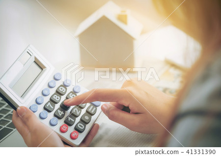 Woman accountant or bank worker uses calculator. 41331390